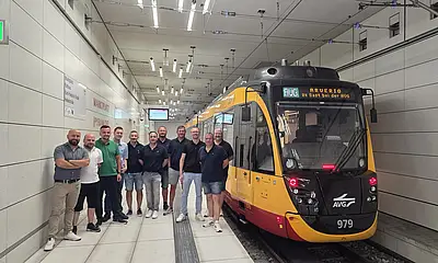 Die Delegation von Arverio steht an der Haltestelle Marktplatz im Karlsruher Stadtbahntunnel neben einer Stadtbahn der Albtal-Verkehrs-Gesellschaft
