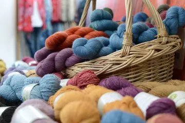 Bunte Wolle und ein Korb bei einem Stand der Messe "Nadelwelt"